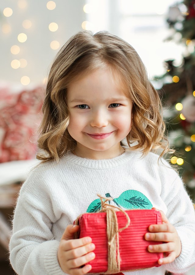 A young girl with a Christmas present