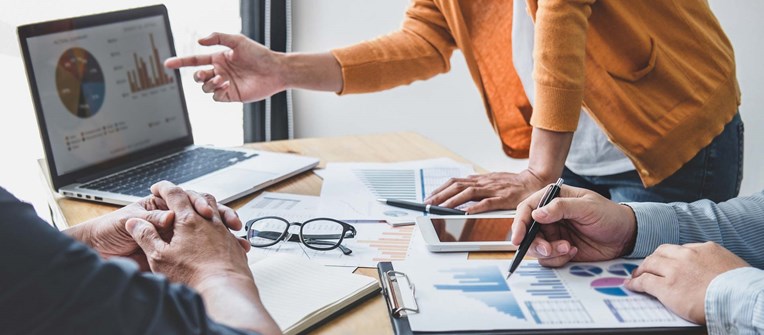 Management team members looking at data and graphs